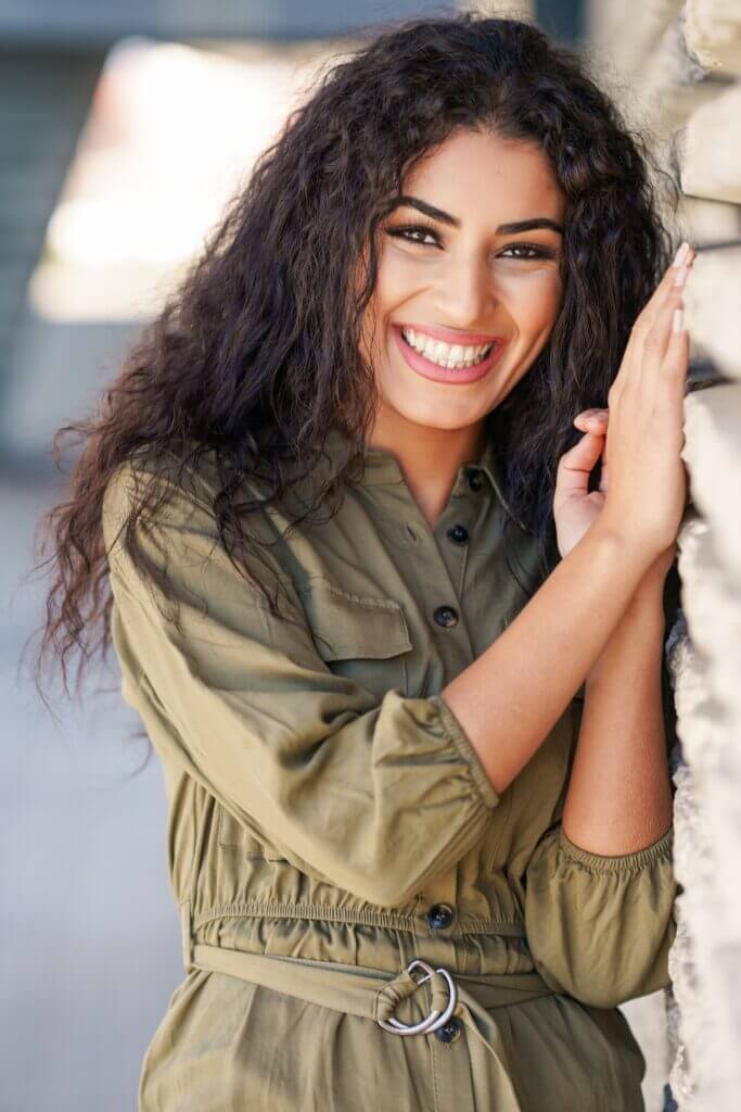 Happy Arab Woman with curly hair outdoors